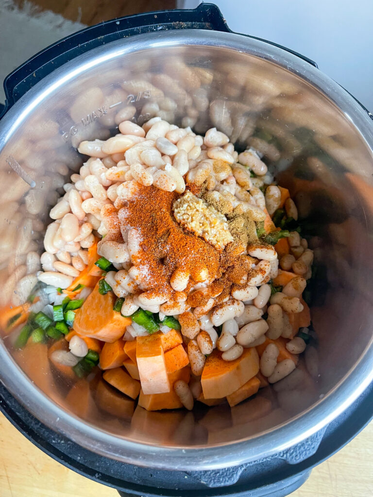 Beans and veggies in pot.